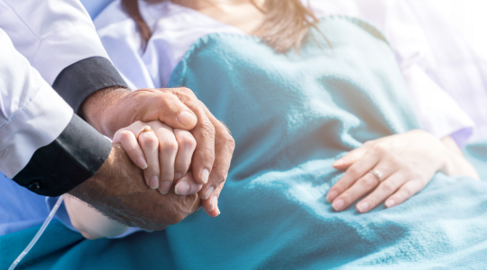 doctor-patient-holding-hands